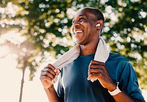 Person smiling with towel around neck