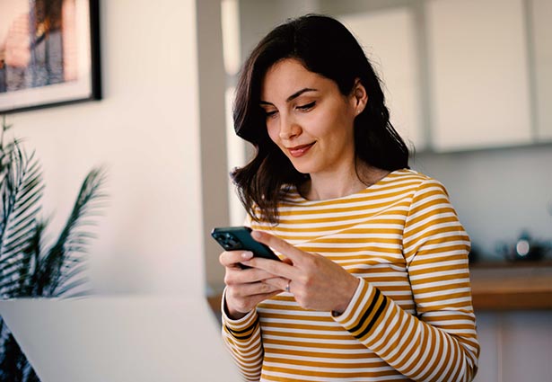 Person looking at mobile phone and smiling